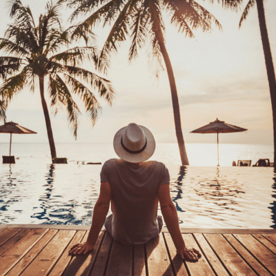 A solo traveller sitting by the pool